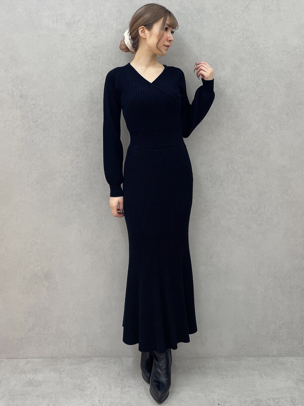 ホワイト系のダウンジャケット/コート、ブラック系のワンピース、ブラック系のブーツを着用したレディースの秋コーディネートの5枚目の写真