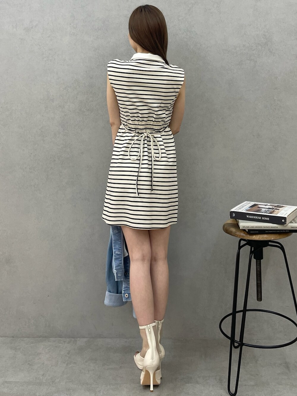 ホワイト系のワンピース、ホワイト系のブーツ、ブルー系のデニムジャケットを着用したレディースの春コーディネートの4枚目の写真