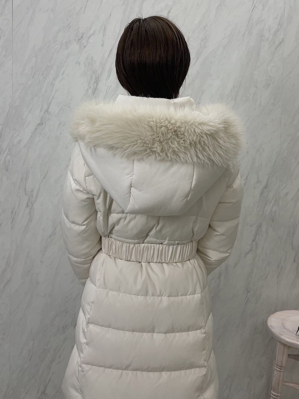 ブラック系のブーツ、ブラック系のワンピース、ホワイト系のダウンジャケット/コートを着用したレディースの夏コーディネートの9枚目の写真