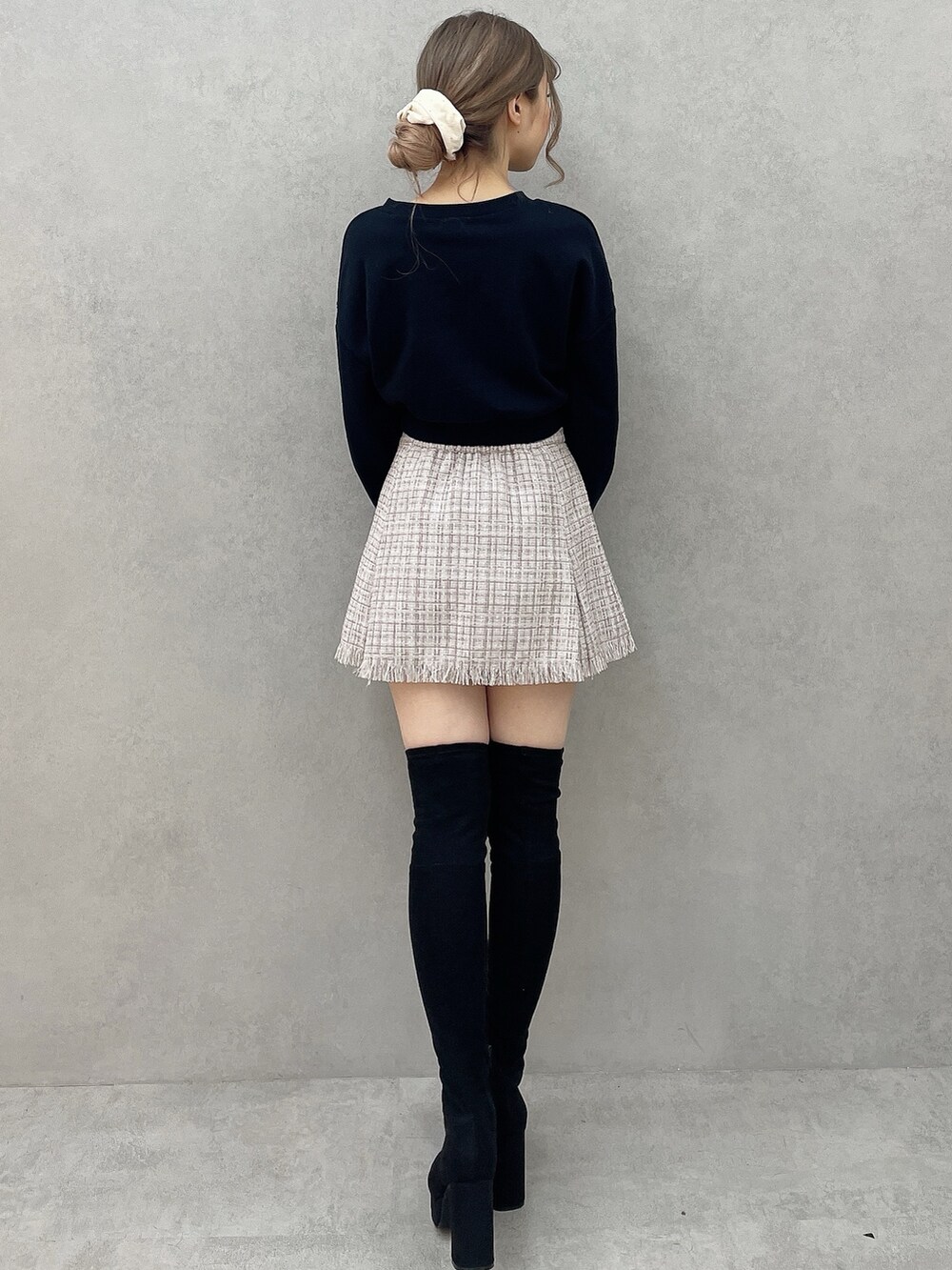 ホワイト系のダウンジャケット/コート、パープル系のスカート、ブラック系のブーツを着用したレディースの秋コーディネートの7枚目の写真