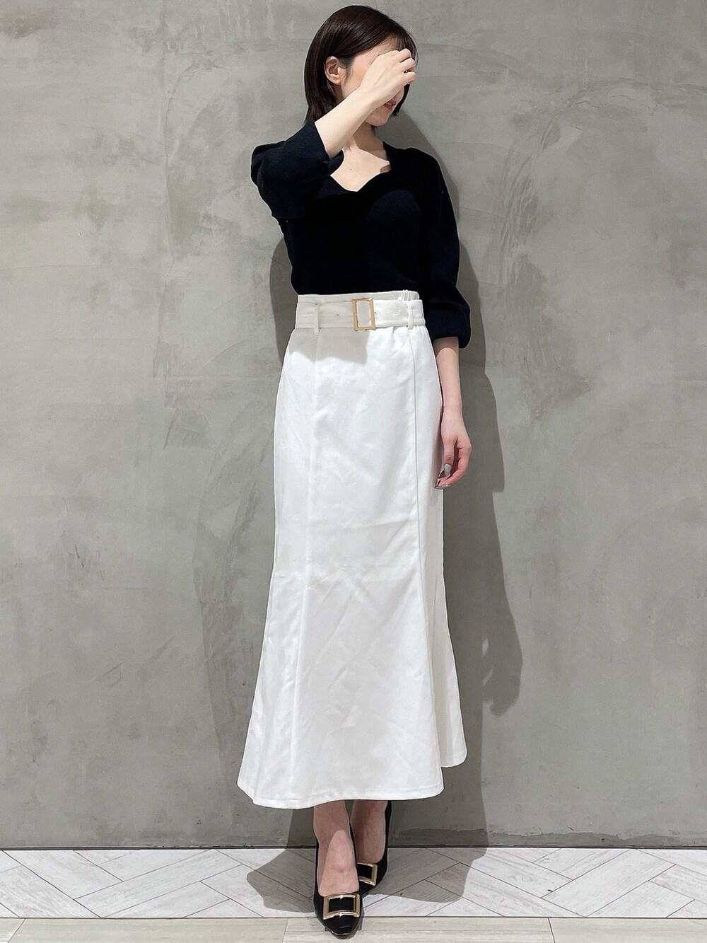 ブラック系のパンプス、ブラック系のニット/セーター、ホワイト系のデニムジャケットを着用したレディースの冬コーディネートの5枚目の写真