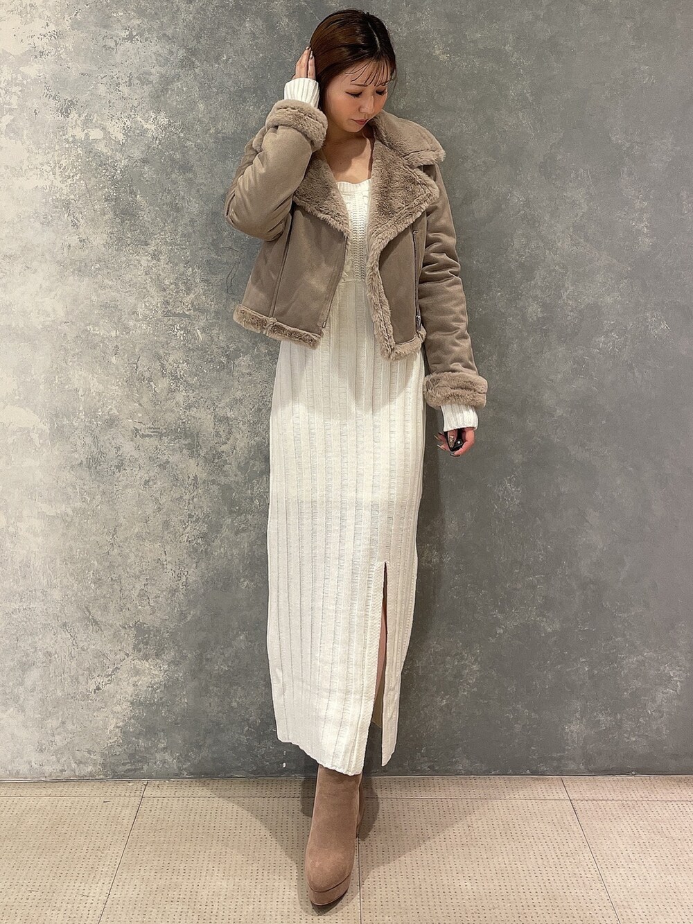 ベージュ系のブルゾン、ホワイト系のワンピース、ベージュ系のブーツを着用したレディースの秋コーディネートの2枚目の写真