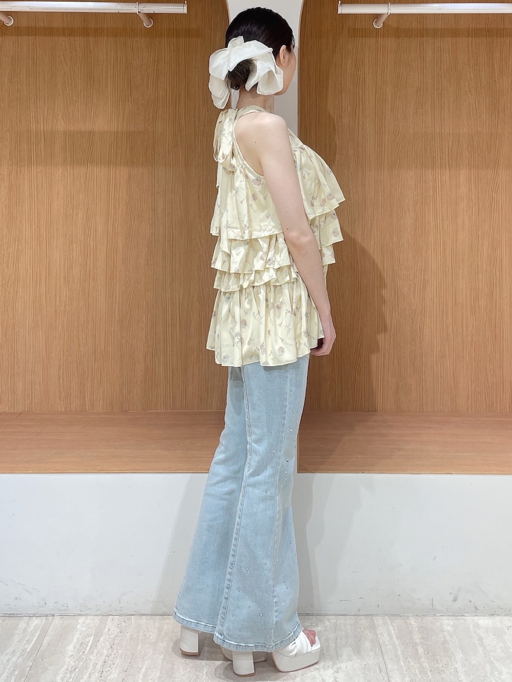 イエロー系のその他トップス、ブルー系のデニムパンツ、ホワイト系のサンダルを着用したレディースの春コーディネートの3枚目の写真