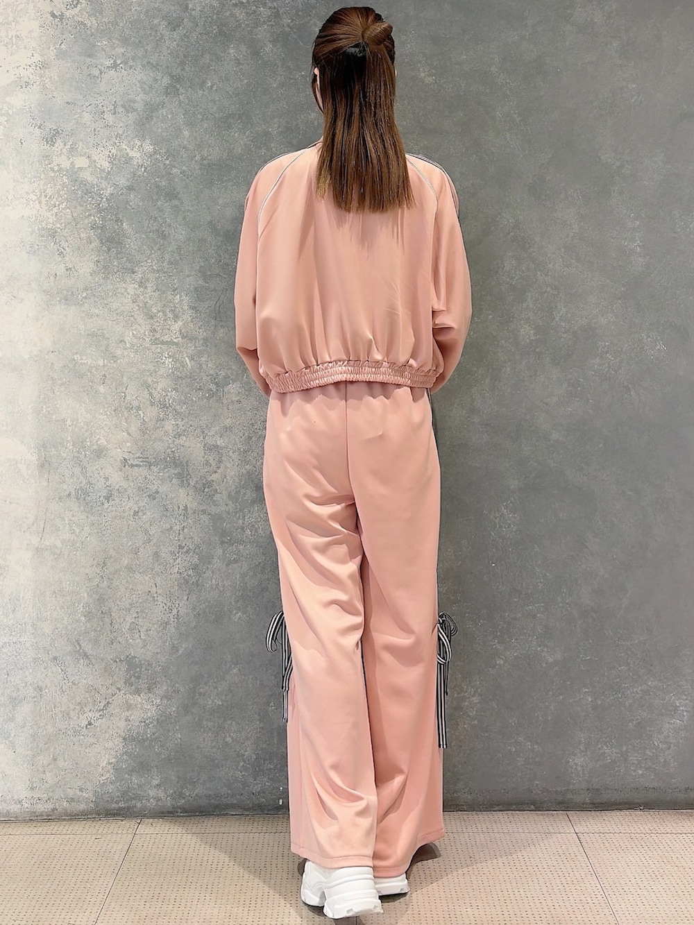 ピンク系のその他アウター、ピンク系のその他パンツ、ホワイト系のニット/セーターを着用したレディースの冬コーディネートの3枚目の写真