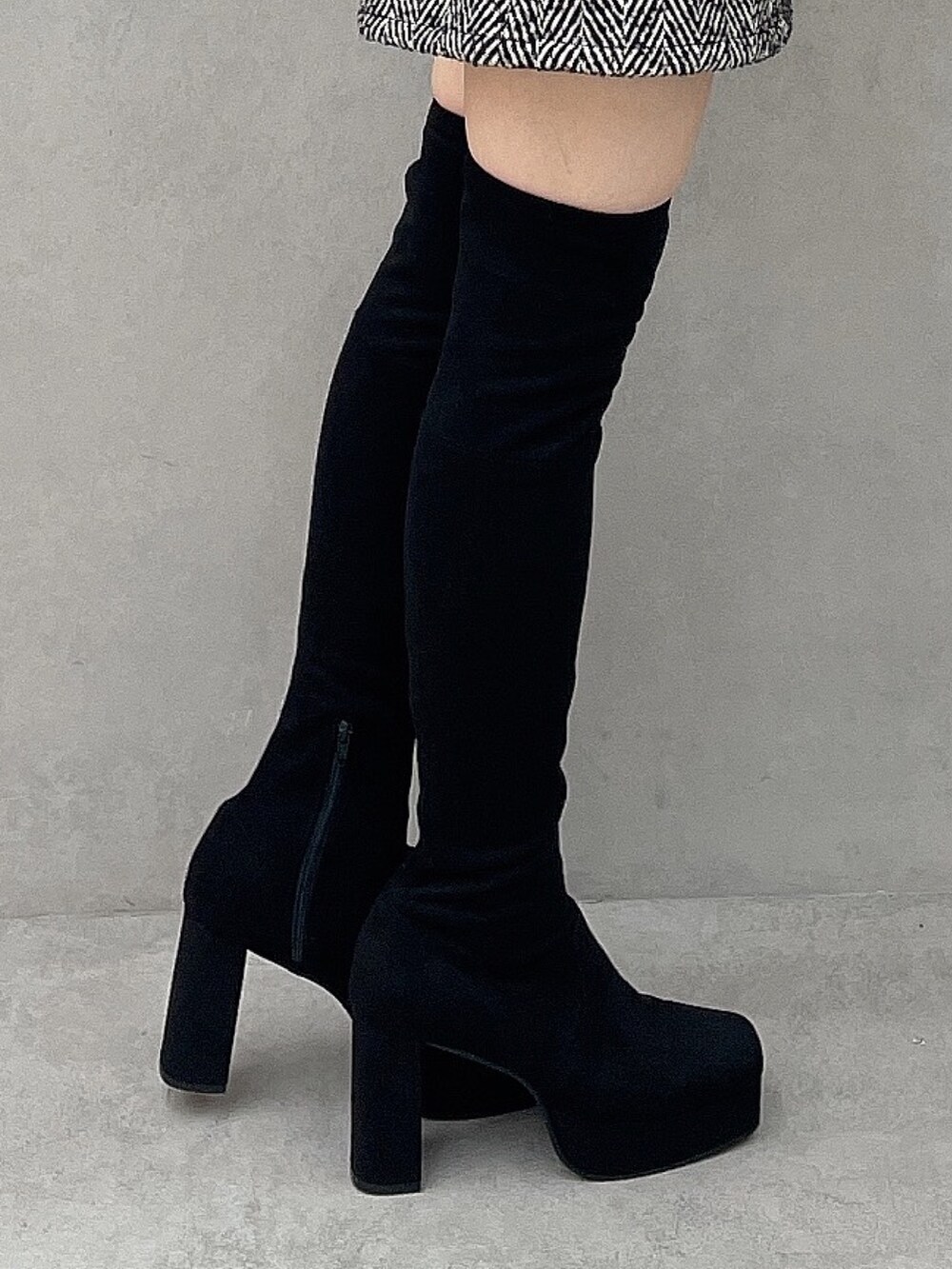 ブルー系のワンピース、ブラック系のハンドバッグ、ブラック系のブーツを着用したレディースの秋コーディネートの8枚目の写真