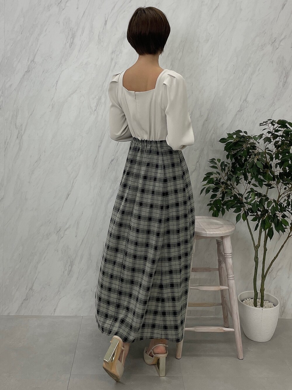 ベージュ系のサンダル、グレー系のテーラードジャケット、ホワイト系のワンピースを着用したレディースの秋コーディネートの6枚目の写真