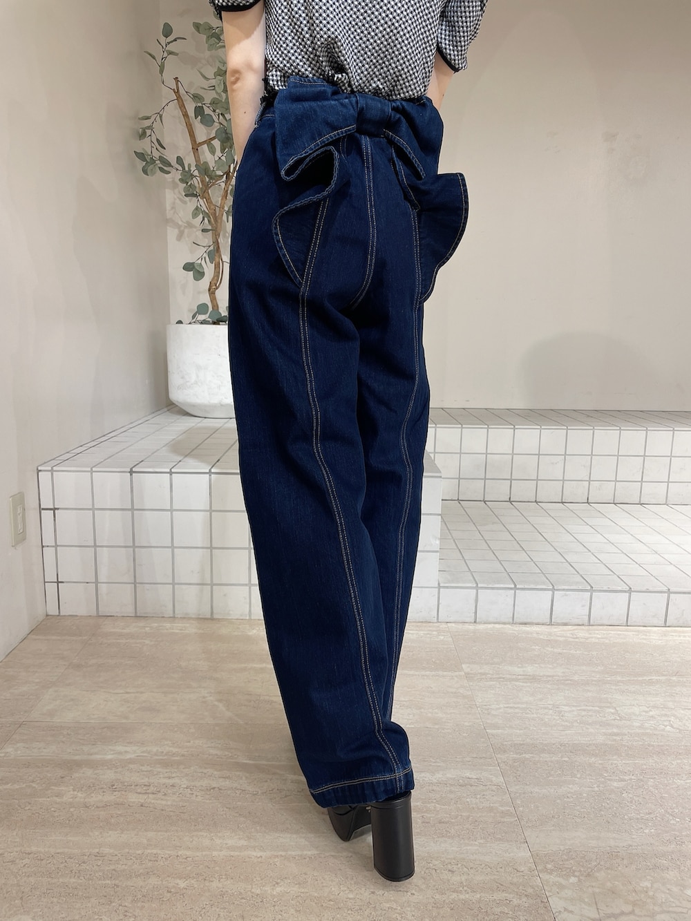 ブラック系のサンダル、ブルー系のデニムパンツ、ブラック系のTシャツ/カットソーを着用したレディースの夏コーディネートの6枚目の写真