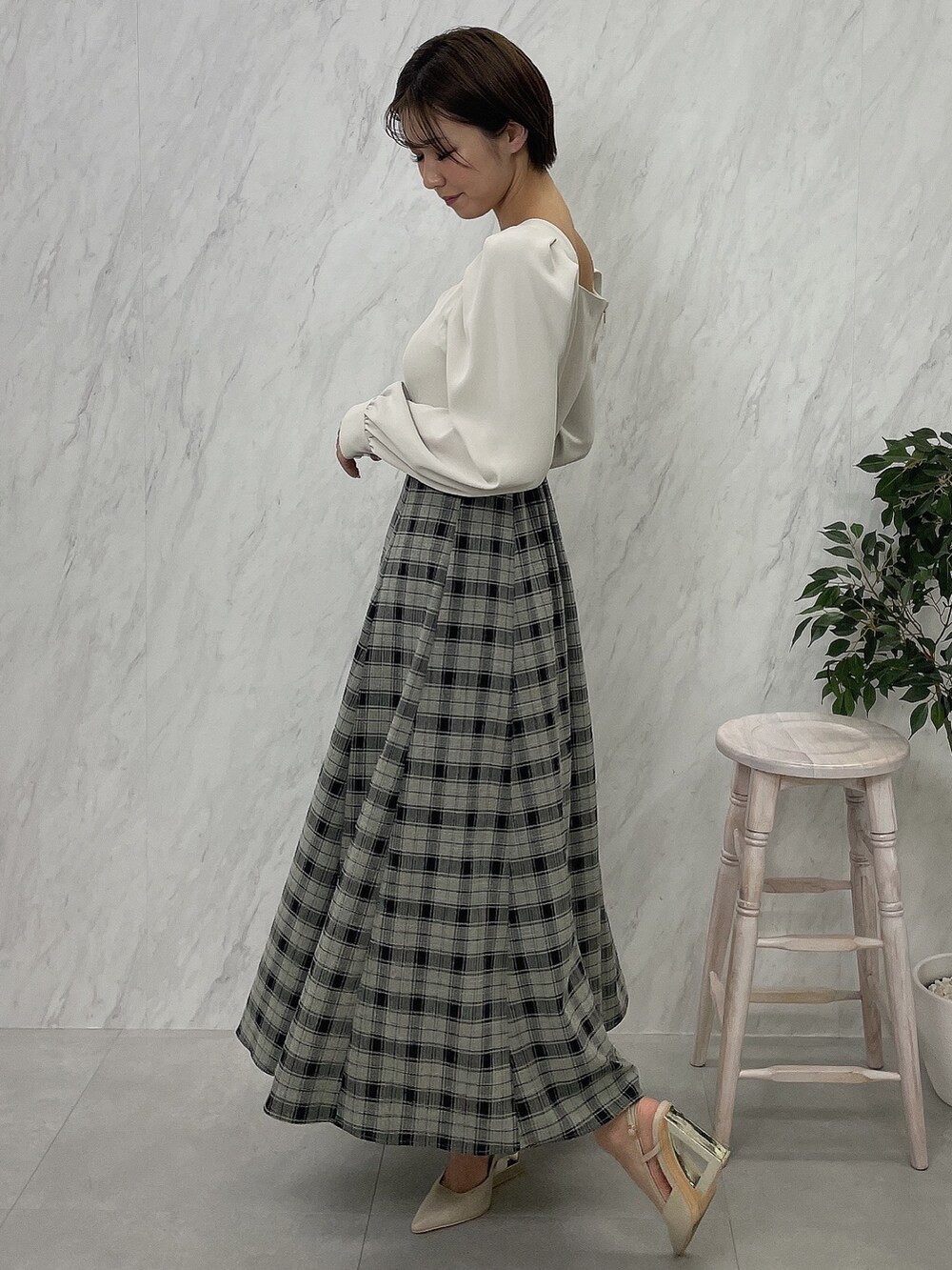 ベージュ系のサンダル、グレー系のテーラードジャケット、ホワイト系のワンピースを着用したレディースの秋コーディネートの5枚目の写真