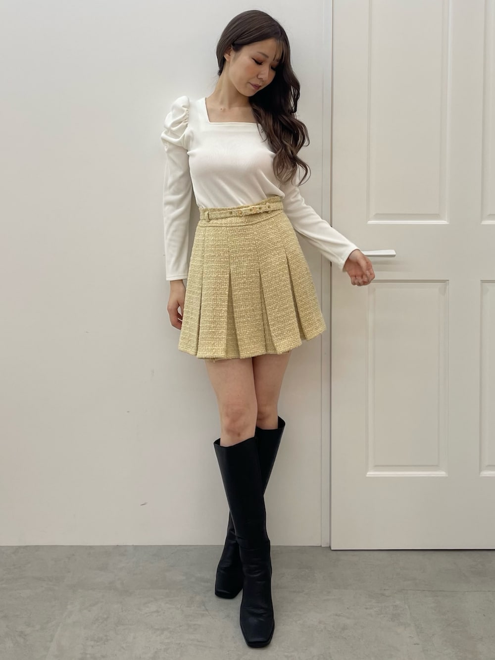 イエロー系のテーラードジャケット、イエロー系のスカート、ホワイト系のTシャツ/カットソーを着用したレディースの秋コーディネートの4枚目の写真