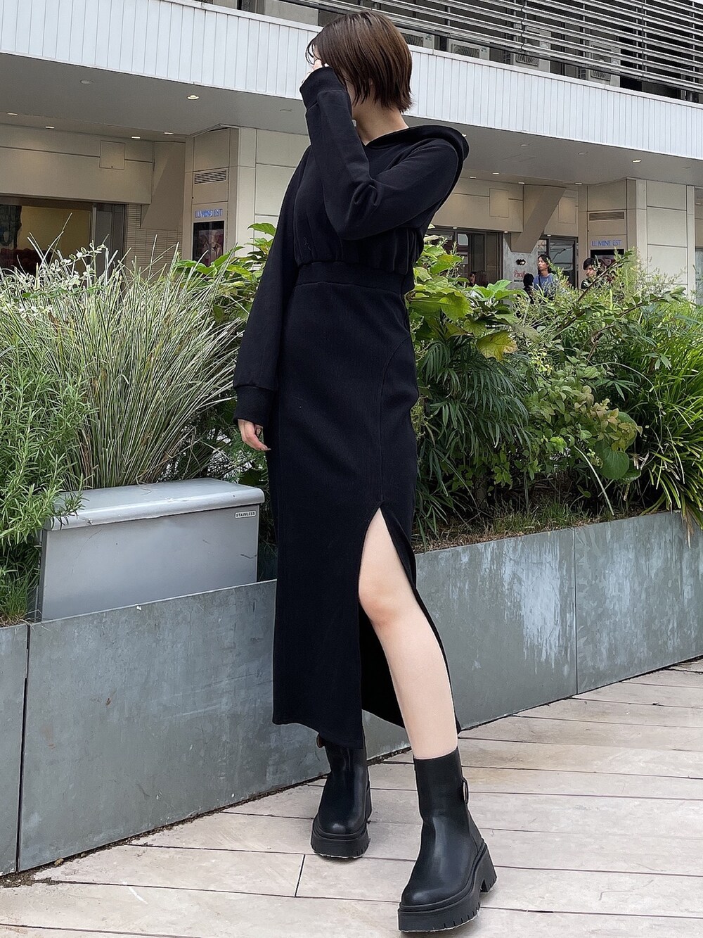 ブラック系のワンピース、ブラック系のブーツを着用したレディースの秋コーディネートの3枚目の写真