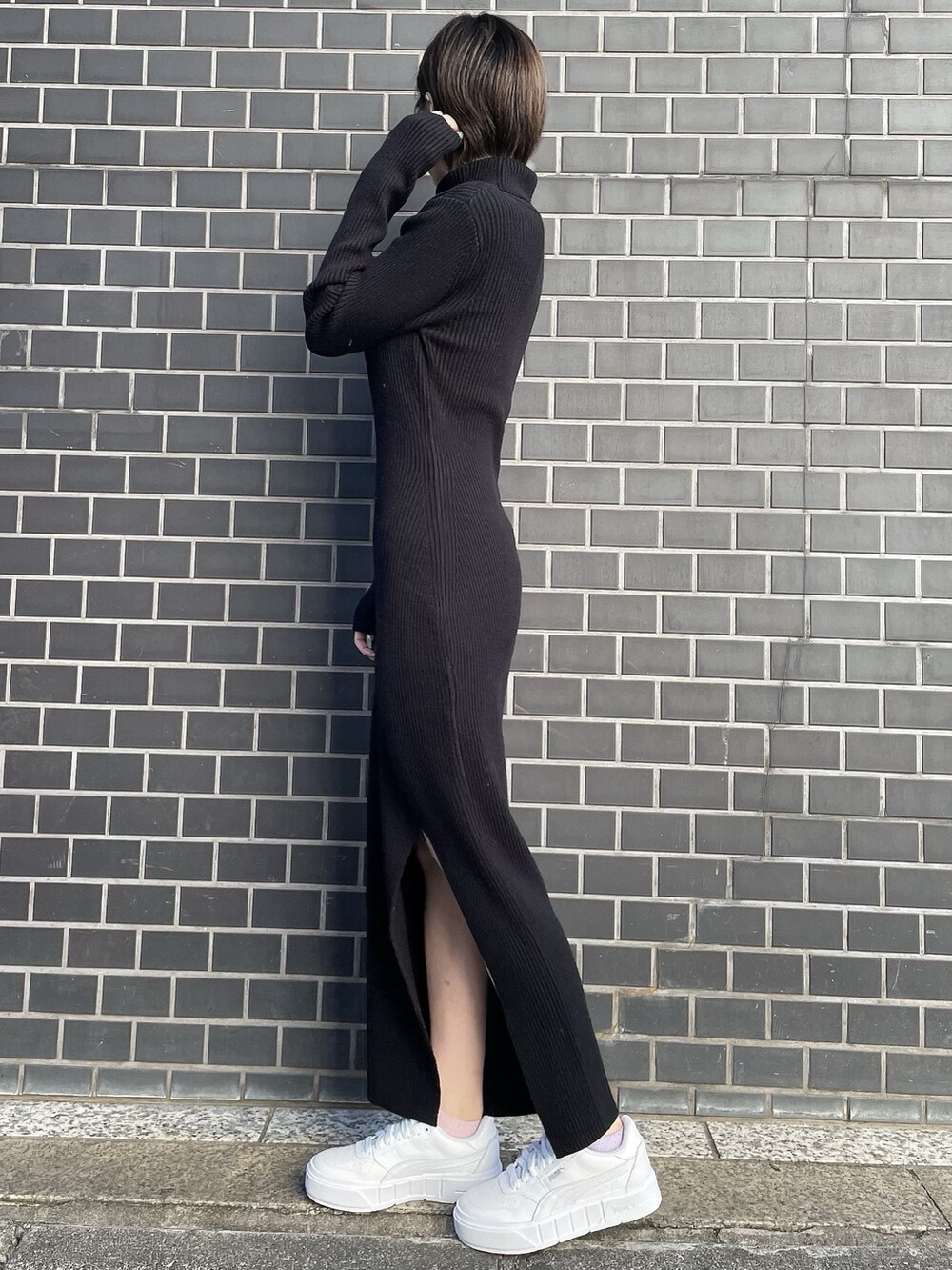 ブラック系のワンピース、ホワイト系のブルゾン、ホワイト系のスニーカーを着用したレディースの冬コーディネートの6枚目の写真