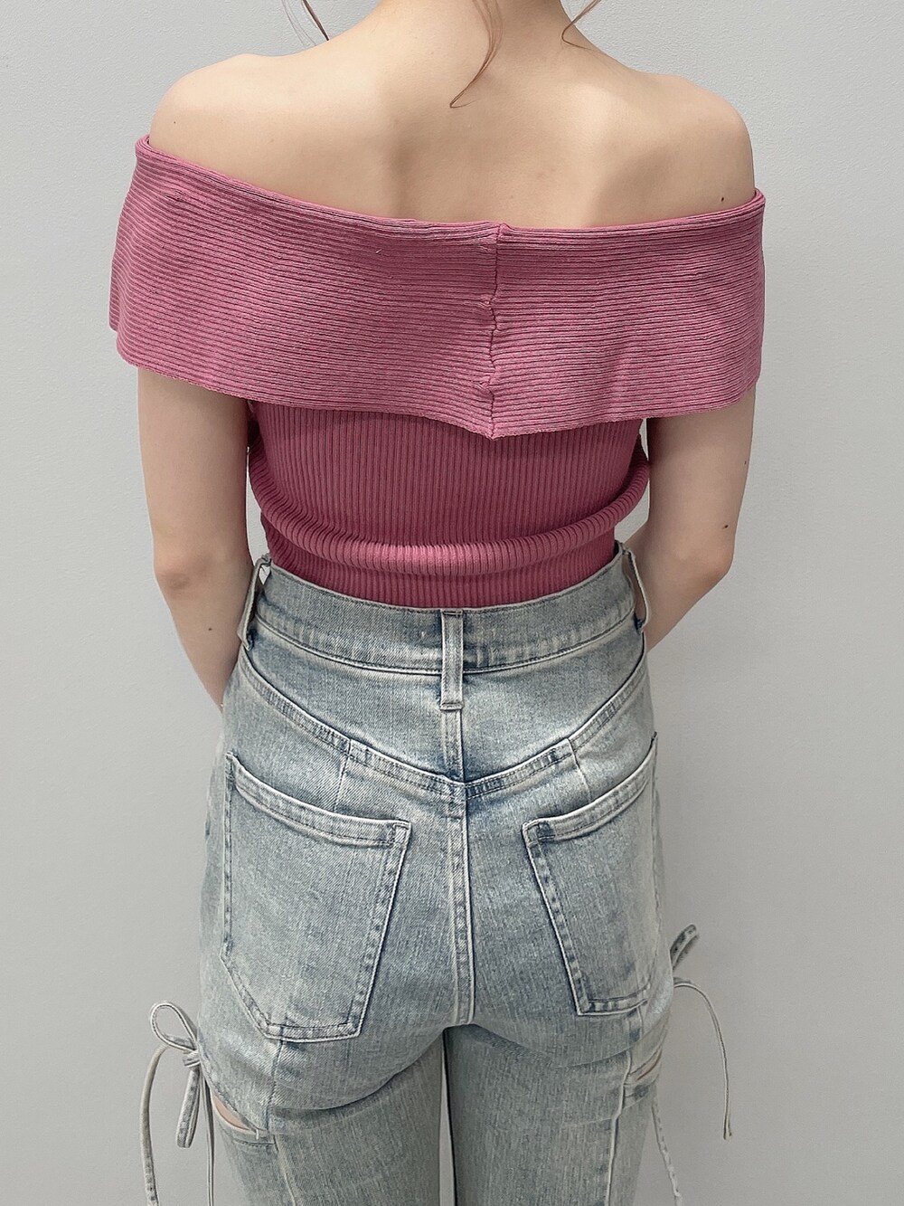 ピンク系のニット/セーター、ブルー系のデニムパンツ、ブラック系のサンダルを着用したレディースの春コーディネートの5枚目の写真
