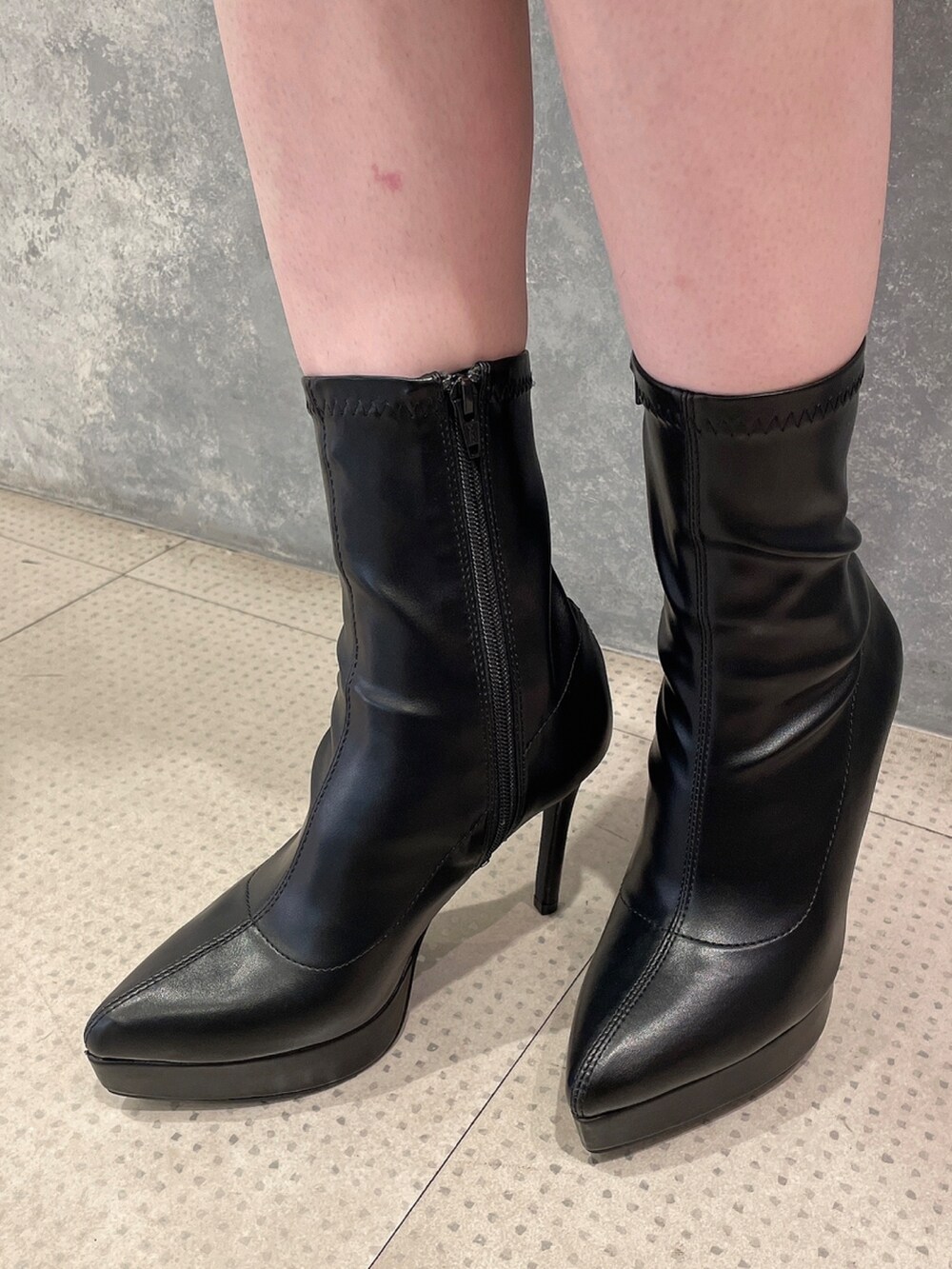 パープル系のワンピース、ブラック系のブーツを着用したレディースの秋コーディネートの7枚目の写真