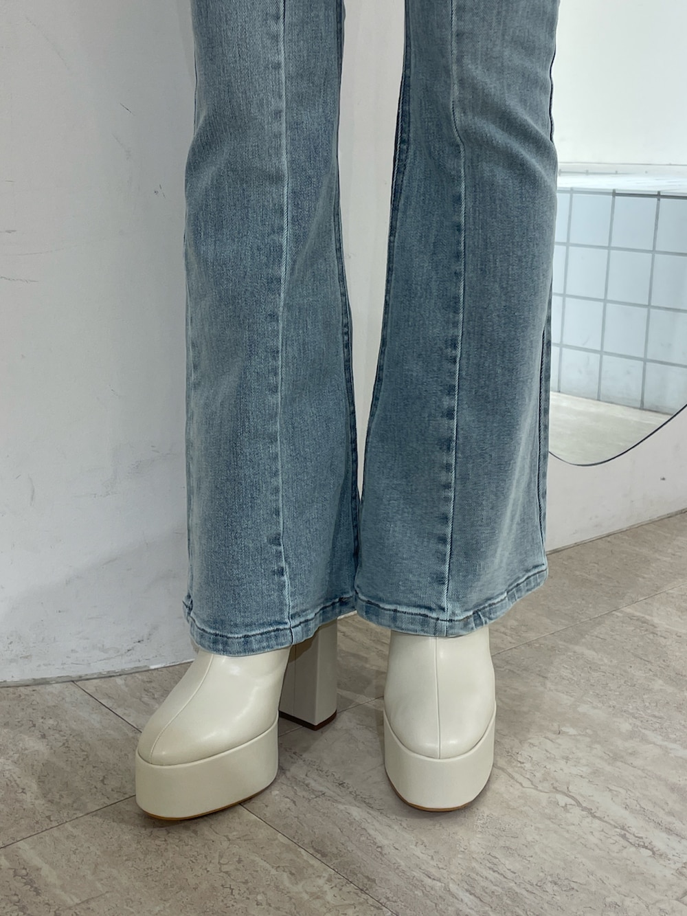 ピンク系のニット/セーター、ブルー系のデニムパンツ、ホワイト系のブーツを着用したレディースの冬コーディネートの8枚目の写真