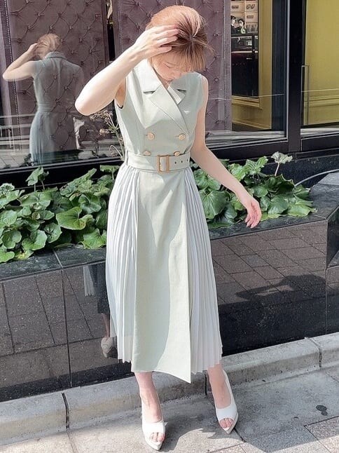 ホワイト系のパンプス、グリーン系のワンピース、ゴールド系のネックレスを着用したレディースの春コーディネートの2枚目の写真