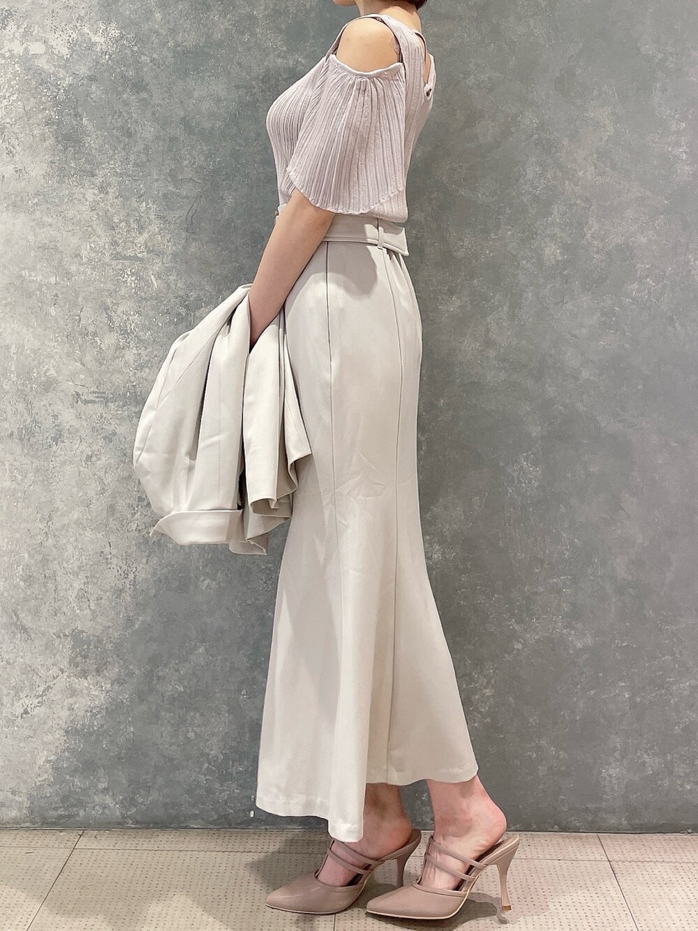 ホワイト系のテーラードジャケット、ホワイト系のスカート、ピンク系のパンプスを着用したレディースの春コーディネートの3枚目の写真