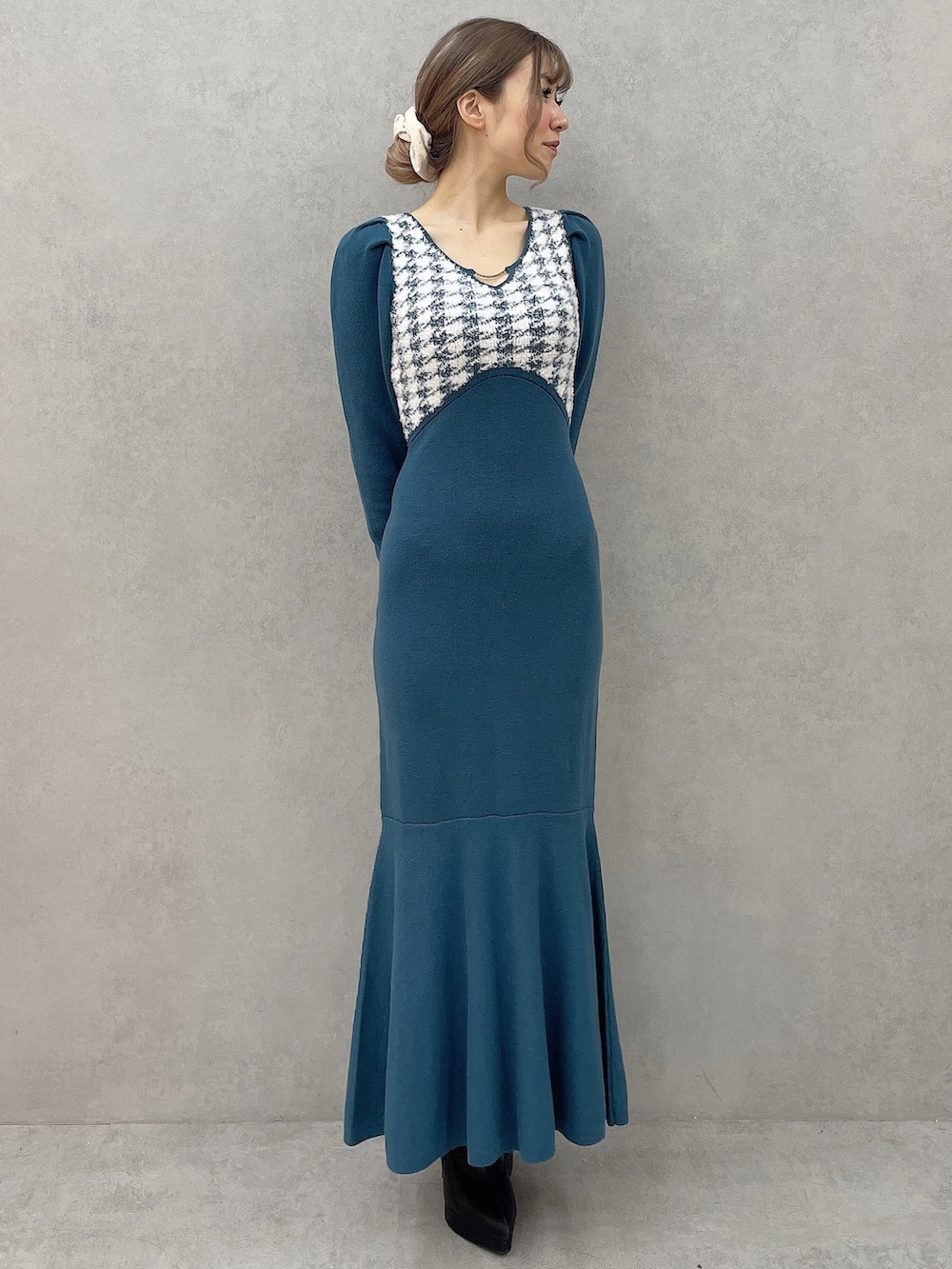 ブルー系のワンピース、ブラック系のブーツを着用したレディースの秋コーディネートの2枚目の写真