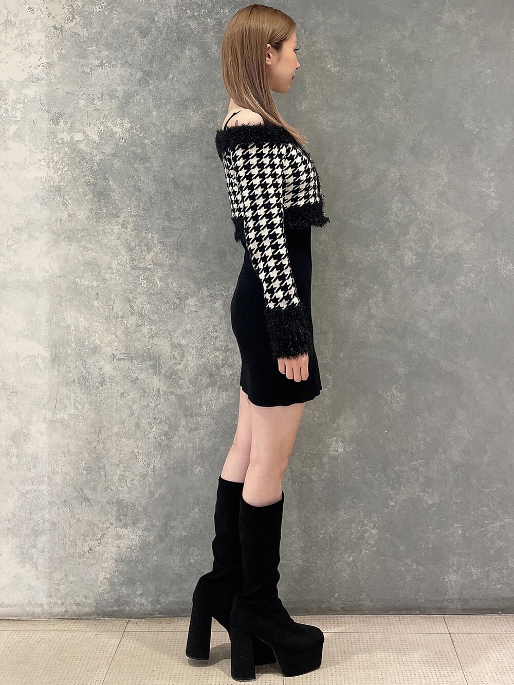 ブラック系のワンピース、その他のブーツを着用したレディースの秋コーディネートの2枚目の写真