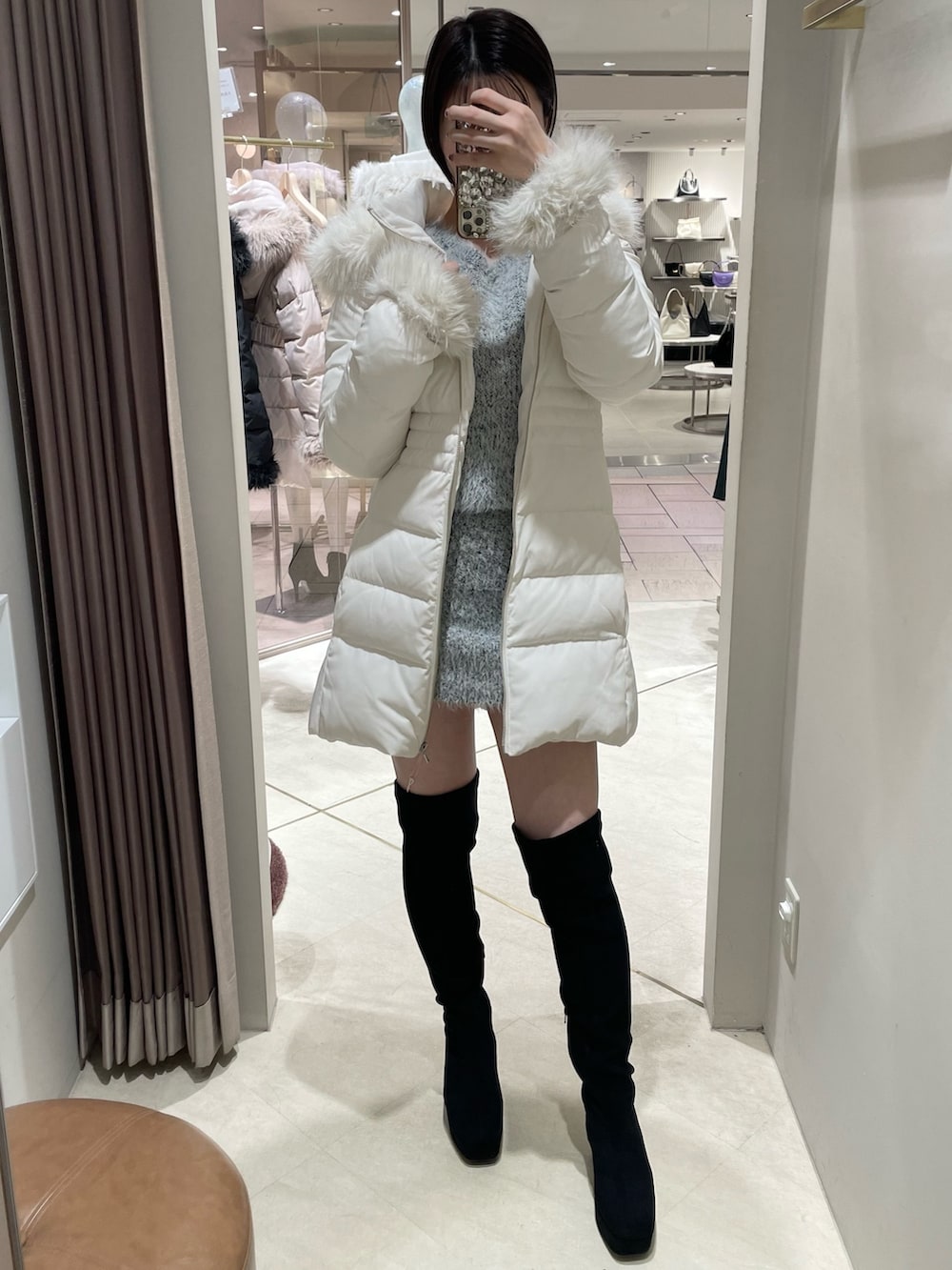 ホワイト系のダウンジャケット/コート、その他のワンピース、ブラック系のブーツを着用したレディースの秋コーディネートの7枚目の写真