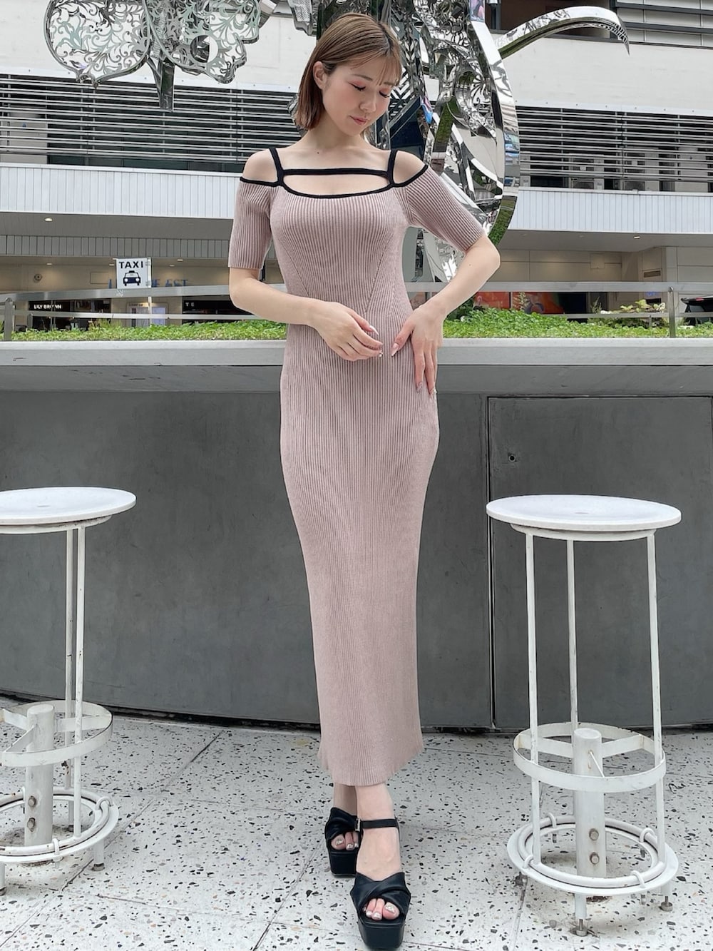 ベージュ系のワンピース、ブラック系のサンダルを着用したレディースの春コーディネートの3枚目の写真