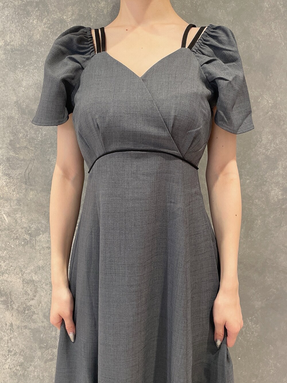 グレー系のワンピース、ブラック系のサンダル、グレー系のシュシュを着用したレディースの夏コーディネートの8枚目の写真