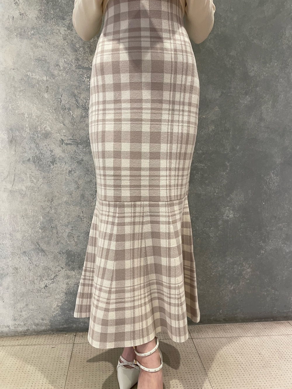 ホワイト系のワンピース、ホワイト系のパンプス、グレー系のシュシュを着用したレディースの秋コーディネートの5枚目の写真