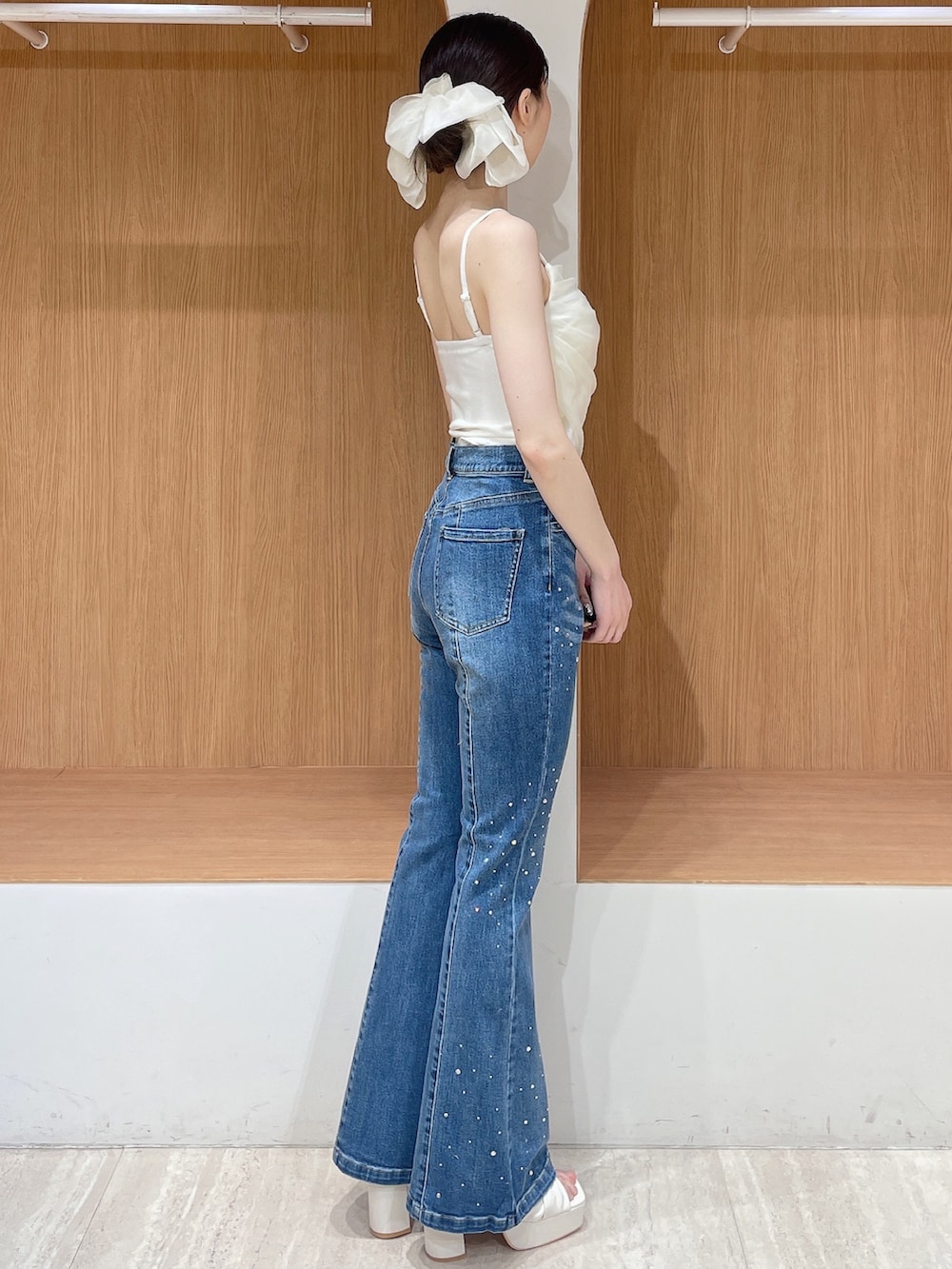 ホワイト系のカーディガン/ボレロ、ブルー系のデニムパンツ、ホワイト系のサンダルを着用したレディースの春コーディネートの5枚目の写真