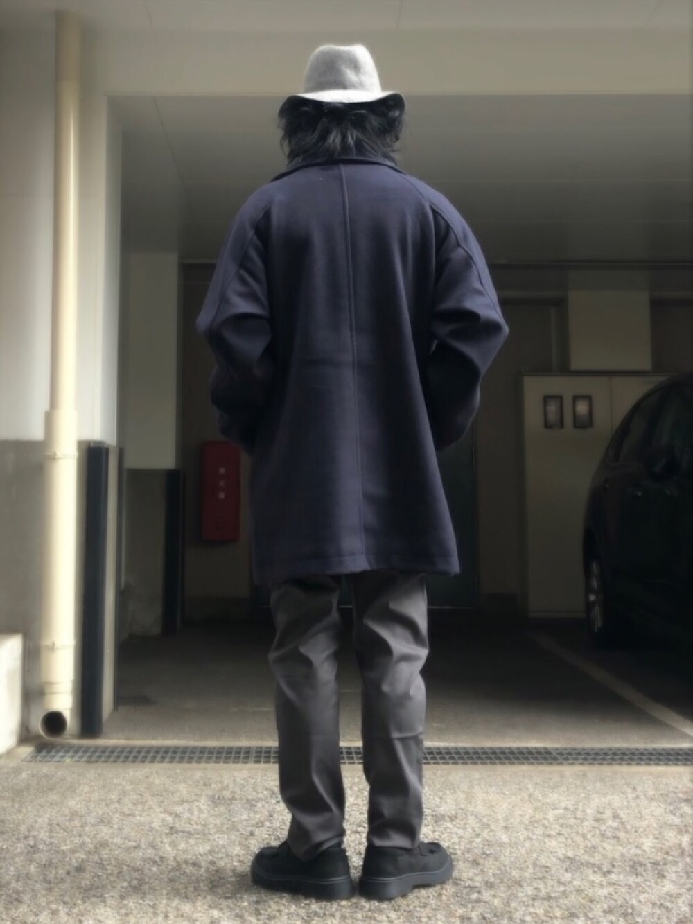 ブルー系のピーコート、ブラック系のローファー、シルバー系のネックレスを着用したメンズの冬コーディネートの3枚目の写真