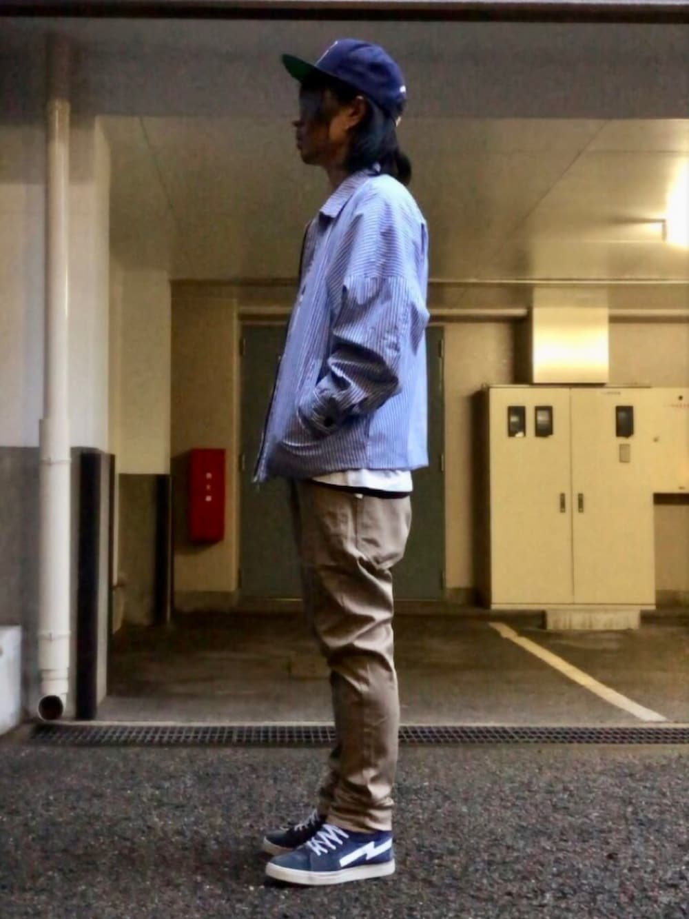 ベージュ系のチノパンツ、ブルー系のスニーカー、ブルー系のブルゾンを着用したメンズの春コーディネートの2枚目の写真