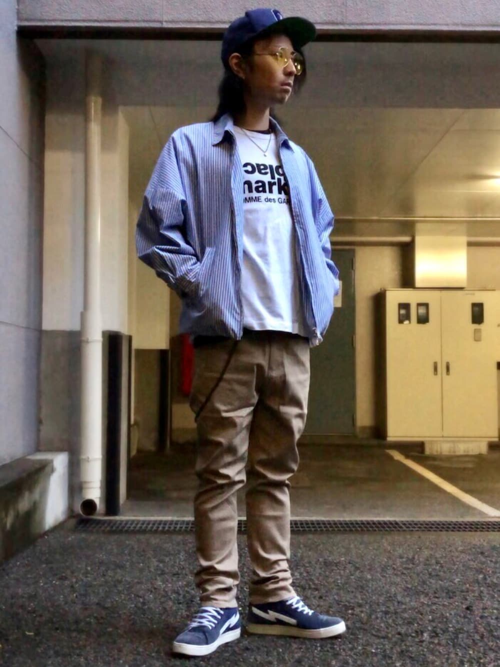 ベージュ系のチノパンツ、ブルー系のスニーカー、ブルー系のブルゾンを着用したメンズの春コーディネートの5枚目の写真