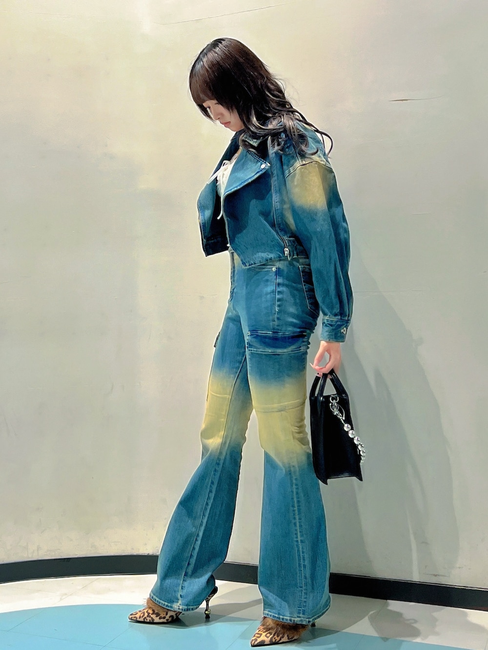 ブルー系のデニムジャケット、ホワイト系のTシャツ/カットソー、ブルー系のデニムパンツを着用したレディースの秋コーディネートの2枚目の写真