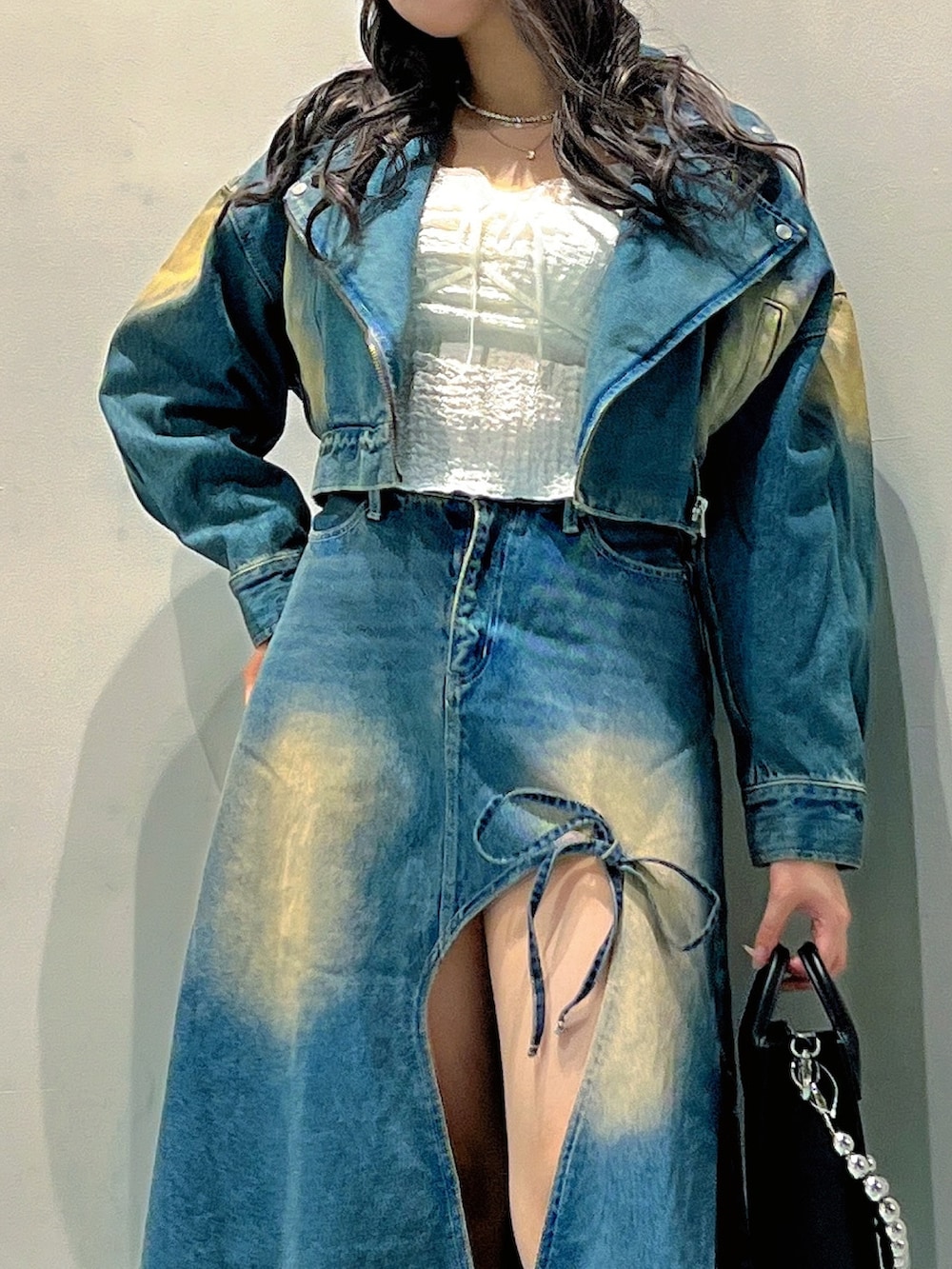 ホワイト系のTシャツ/カットソー、ブルー系のデニムジャケット、ブルー系のデニムスカートを着用したレディースの秋コーディネートの4枚目の写真