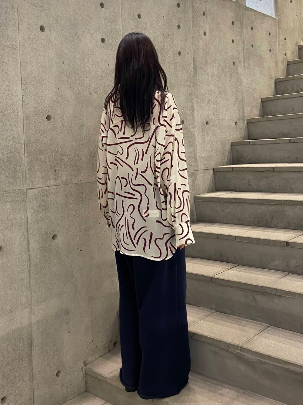 レッド系のシャツ/ブラウス、ブラック系のローファー、ブルー系のスウェットパンツを着用したレディースの冬コーディネートの4枚目の写真