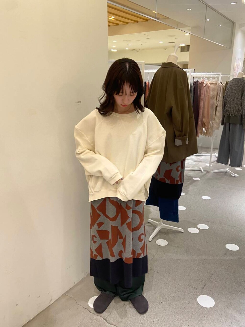 グリーン系のその他パンツ、グレー系のニット/セーター、ホワイト系のTシャツ/カットソーを着用したレディースの秋コーディネートの2枚目の写真