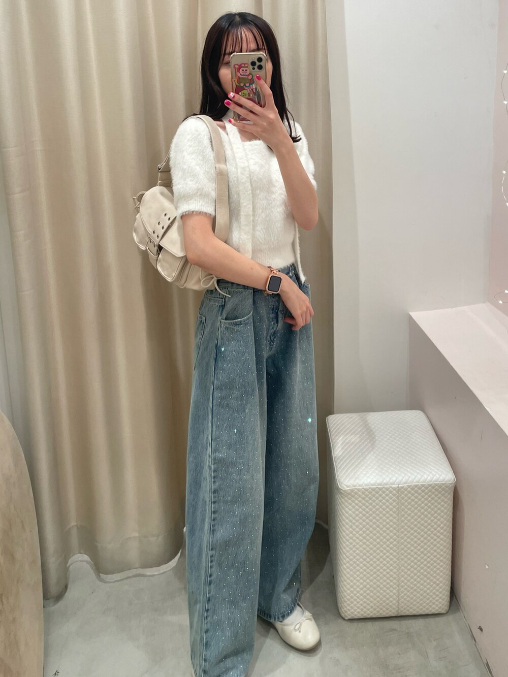 ホワイト系のニット/セーター、ブルー系のパンツ、ホワイト系のショルダーバッグを着用したレディースの秋コーディネートの2枚目の写真