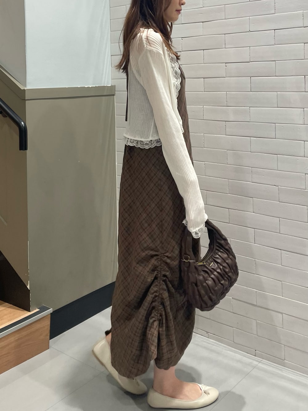 ホワイト系のカーディガン/ボレロ、ブラウン系のワンピース、ブラウン系のショルダーバッグを着用したレディースの夏コーディネートの2枚目の写真
