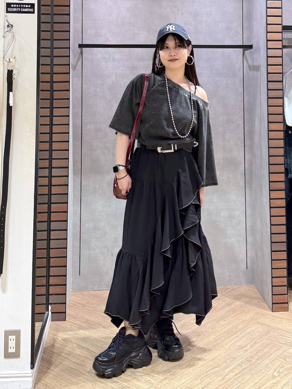 ブラック系のTシャツ/カットソー、ブラック系のスニーカー、ブラック系のキャミソールを着用したレディースの夏コーディネートの7枚目の写真