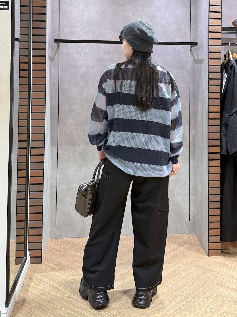 ブラック系のスニーカー、ブラック系のキャミソール、ブラック系のショルダーバッグを着用したレディースの春コーディネートの4枚目の写真