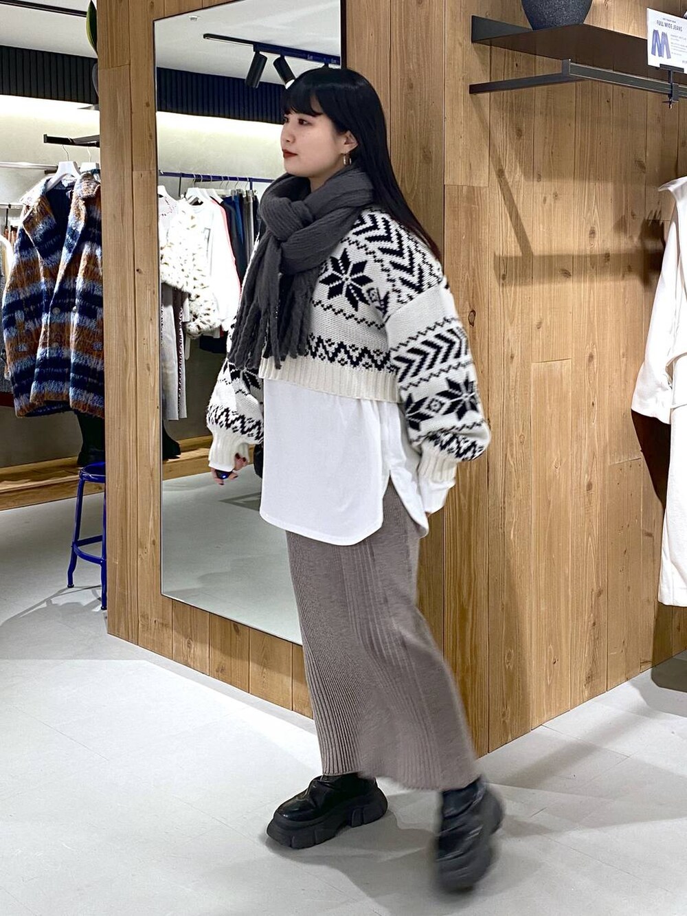 ブラック系のブーツ、ホワイト系のTシャツ/カットソー、ブラック系のショルダーバッグを着用したレディースの冬コーディネートの4枚目の写真