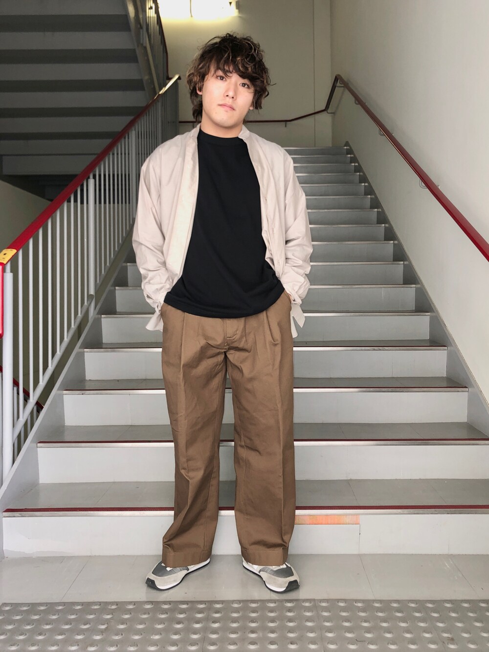 ブラウン系のその他パンツ、グレー系のスニーカー、ブラック系のマウンテンパーカーを着用したメンズの春コーディネートの5枚目の写真