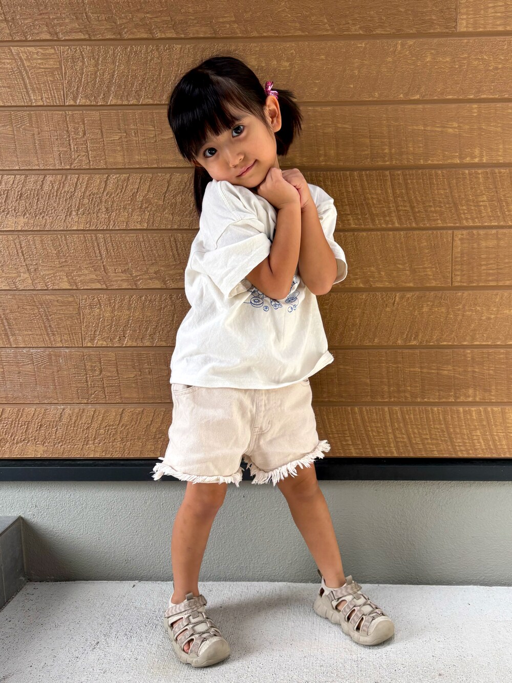 ベージュ系のサンダル、ホワイト系のデニムパンツ、ホワイト系のTシャツ/カットソーを着用したキッズの秋コーディネートの3枚目の写真