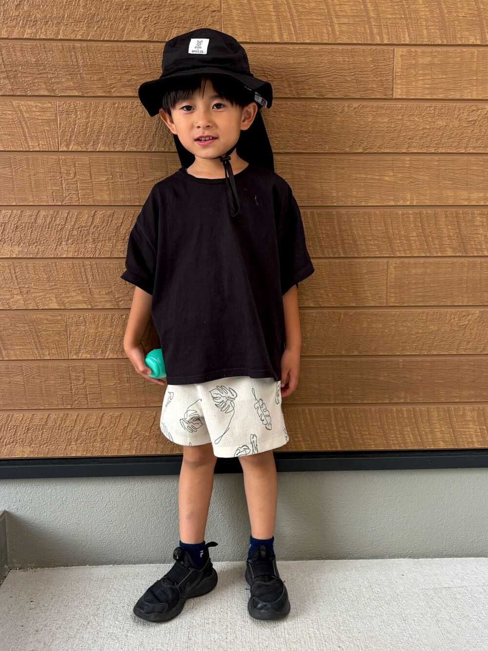 ブラック系のTシャツ/カットソー、ホワイト系のその他パンツ、ブラック系のスニーカーを着用したキッズの春コーディネートの2枚目の写真