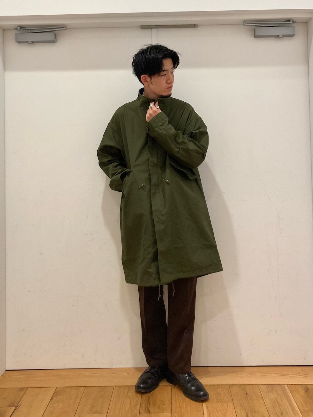 ブラック系のドレスシューズ、ホワイト系のシャツ/ブラウス、グリーン系のモッズコートを着用したメンズの冬コーディネートの3枚目の写真