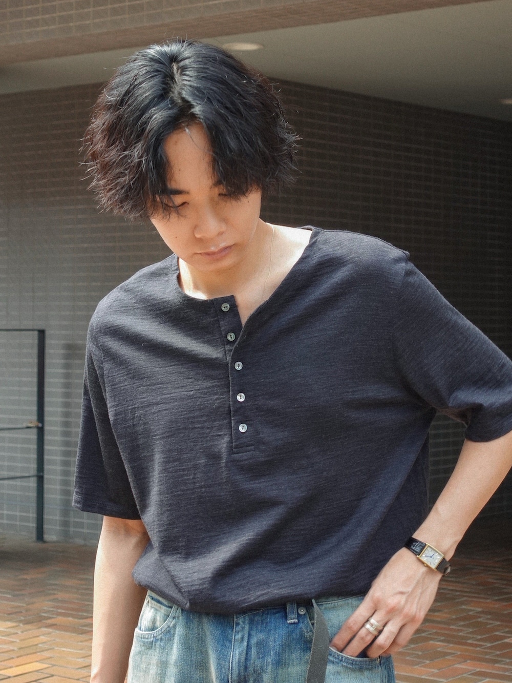 ブラック系のサンダル、ブルー系のデニムパンツ、ブラック系のTシャツ/カットソーを着用したメンズの夏コーディネートの2枚目の写真