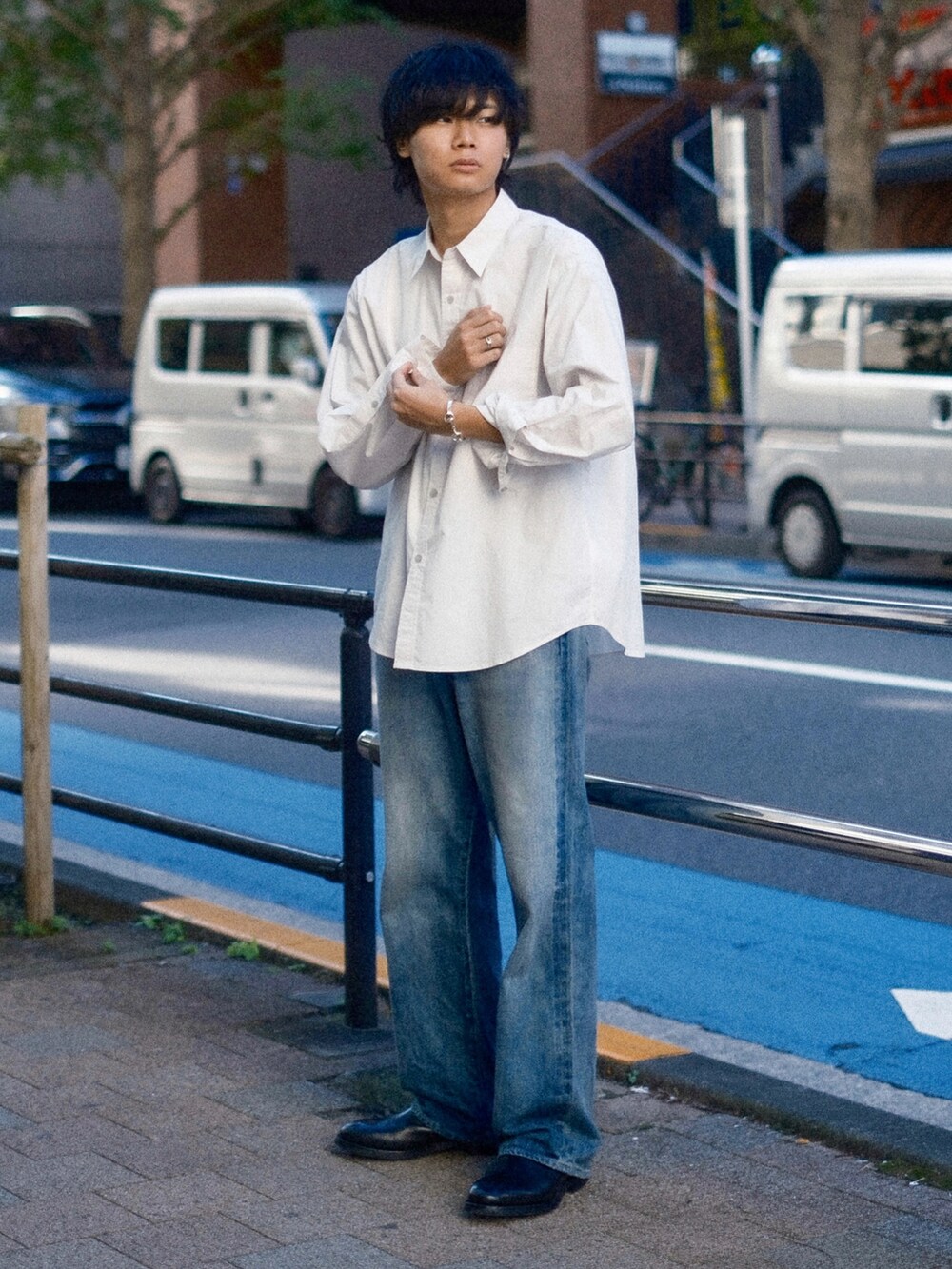 ブルー系のデニムパンツ、グレー系のシャツ/ブラウス、ブラック系のブーツを着用したメンズの秋コーディネートの2枚目の写真