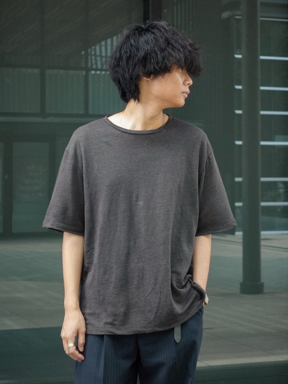 ブラック系のドレスシューズ、ブラウン系のTシャツ/カットソー、グレー系のスラックスを着用したメンズの夏コーディネートの2枚目の写真