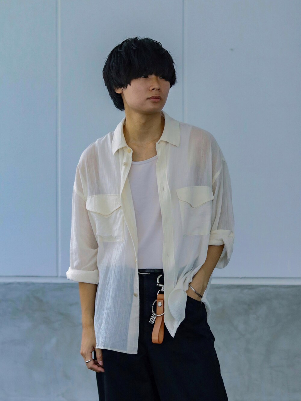 グレー系のタンクトップ、ホワイト系のシャツ/ブラウス、ブラック系のデニムパンツを着用したメンズの夏コーディネートの2枚目の写真