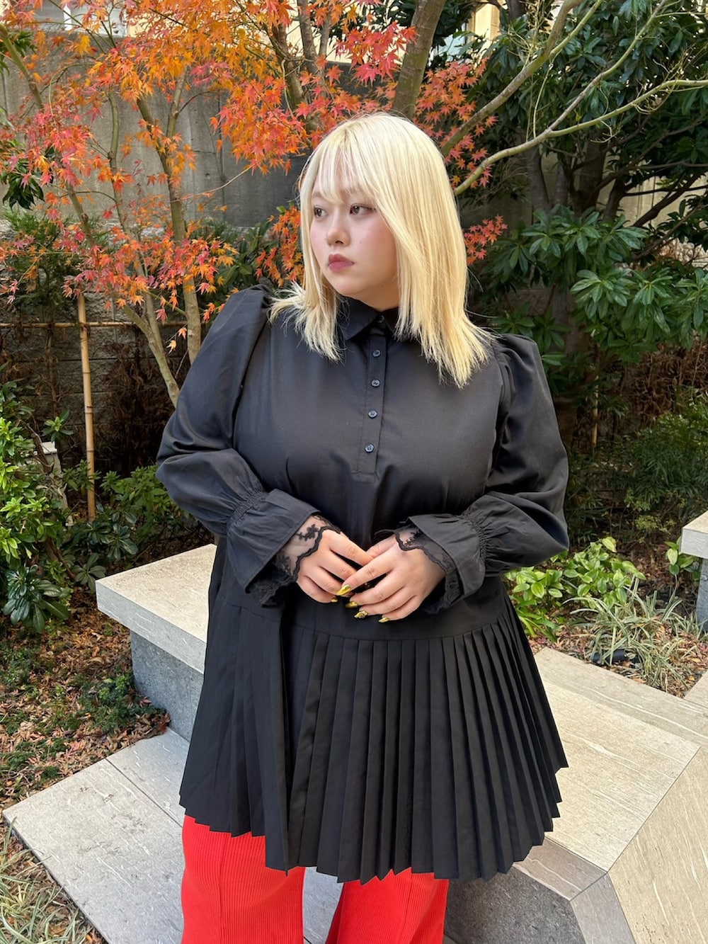 ブラック系のシャツワンピース、レッド系のその他パンツを着用したレディースの冬コーディネートの4枚目の写真