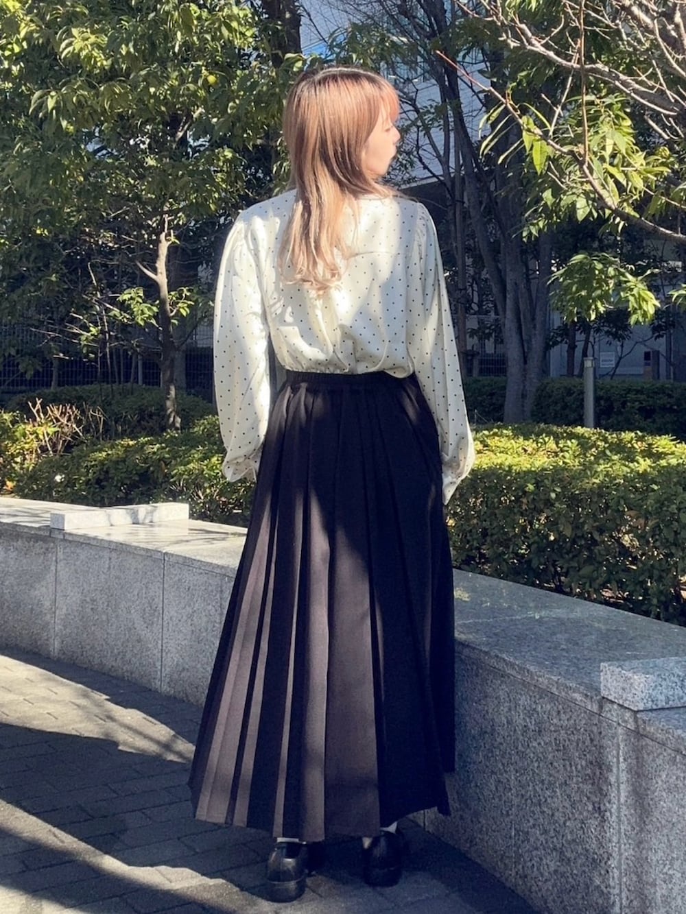 ブラック系のスカート、ホワイト系のシャツ/ブラウスを着用したレディースの冬コーディネートの2枚目の写真