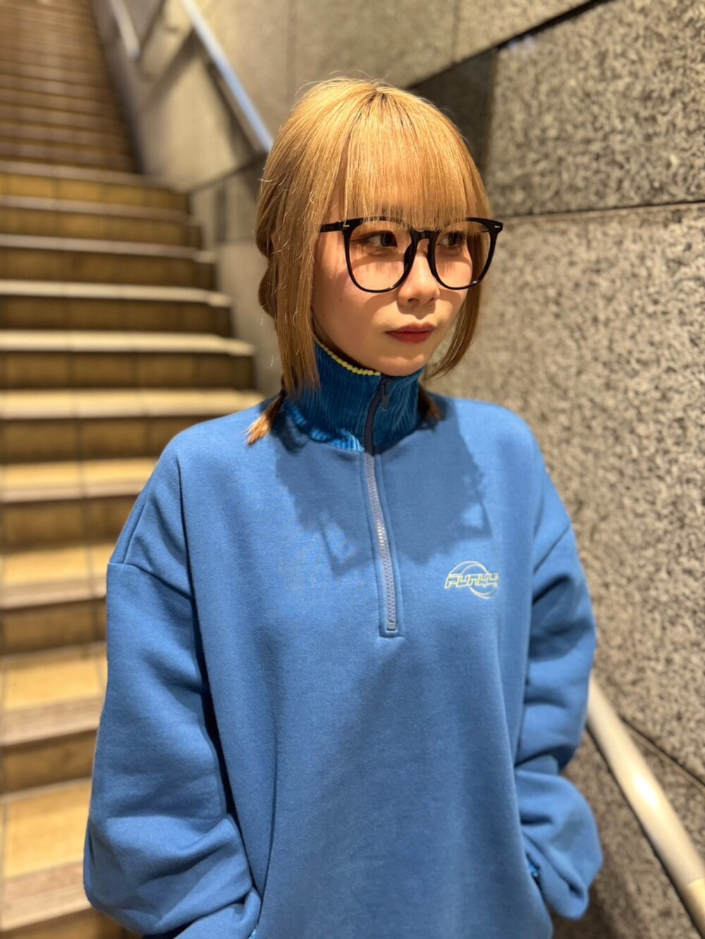 ブルー系のスウェット、ブルー系のデニムパンツを着用したレディースの冬コーディネートの3枚目の写真